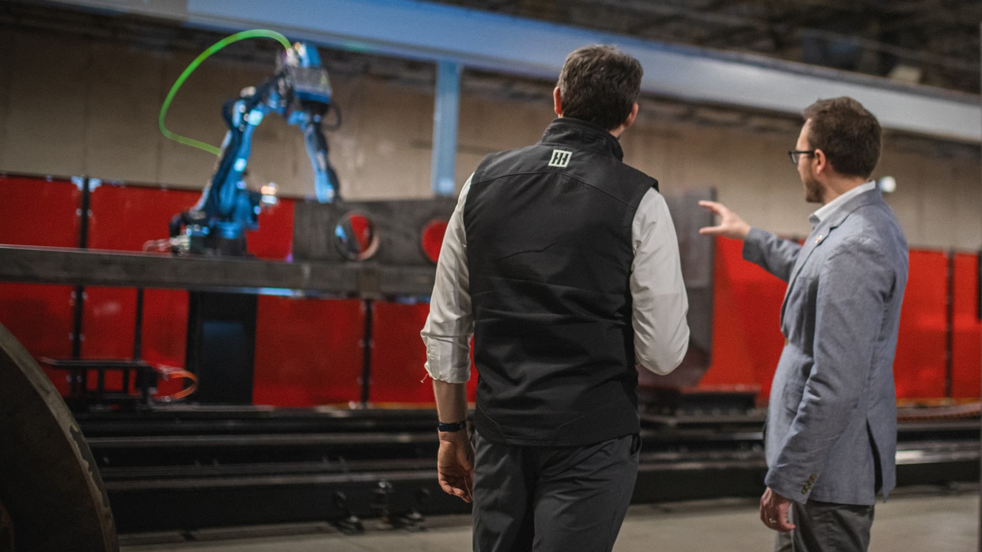 Path Robotics CEO Andy Lonsberry and HII executive Erich Chewing in front of welding cell